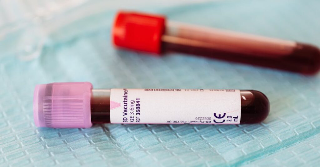 Close-up view of blood sample vials on a medical table, ideal for healthcare and laboratory themes.